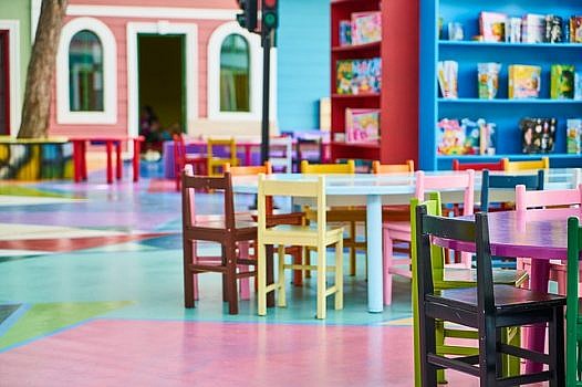 sala przedszkolna, kolorowa z krzesełkami i stolikami