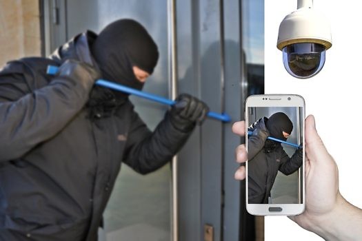 mężczyzna ubrany w czarną kominiarke z łomem włamuje się do telefonu