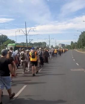 Pielgrzymi idący ulicą.